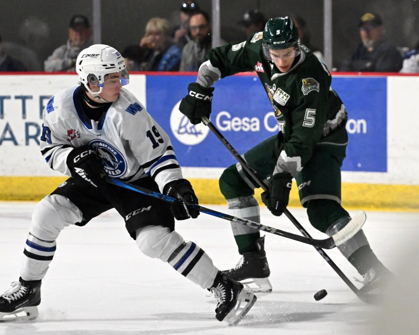 Wenatchee's Miles Cooper battles for the puck